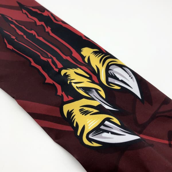 print detail of a compression sleeve in red and yellow