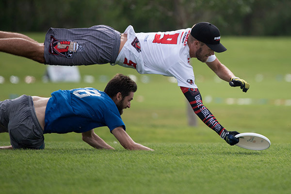 kid wearing a rainbow couloured compresion sleeve and a black singlet