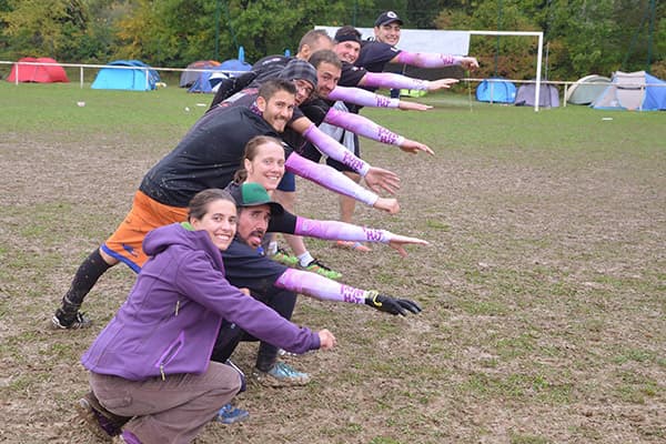 ultimate frisbee player diving horizontally to catch a disc