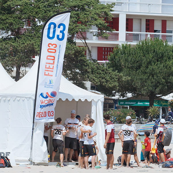 beach flag tent and players on beach