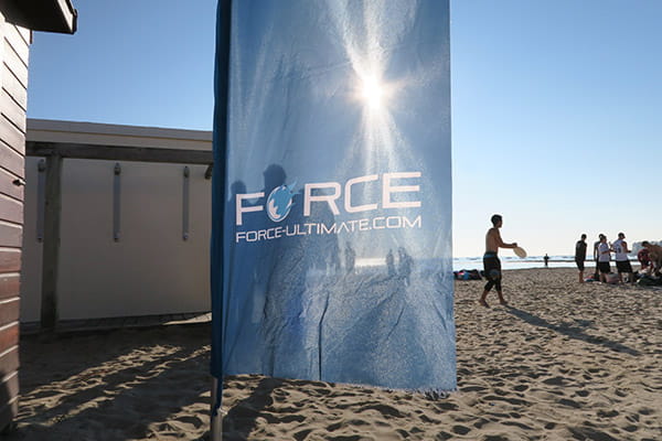 sunlight through a beach flag on a beach