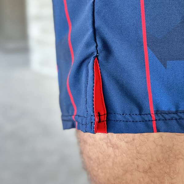 closeup view of the v-cut side of blue shorts